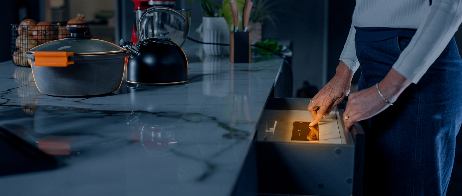 InvisaCook invisible induction cooktop beneath a porcelain countertop in a modern kitchen